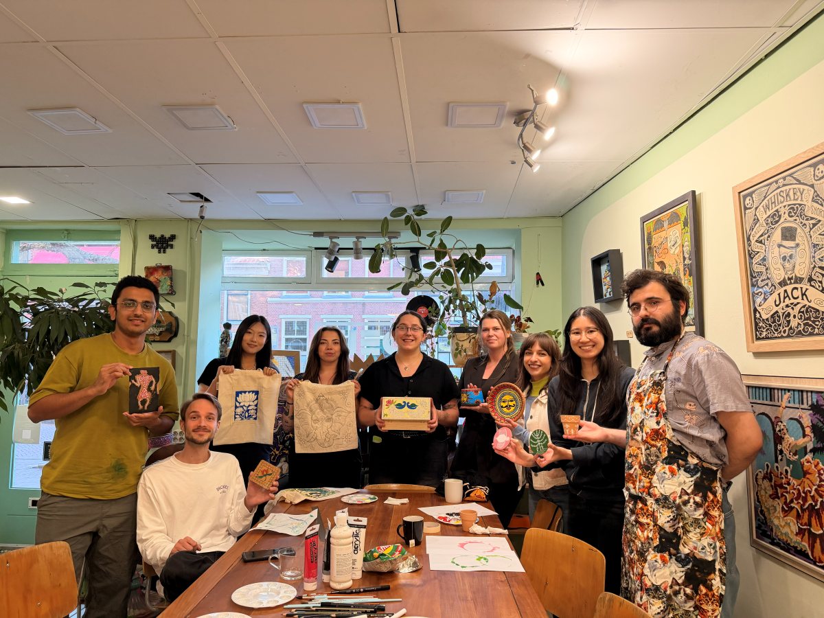 The whole workshop group holding up their finished pieces
